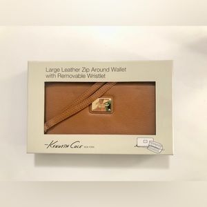 Kenneth Cole 
Large tan leather zip around wallet with removable wristlet.